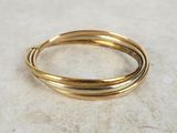 a close up of a gold bang bracelet on a marble surface