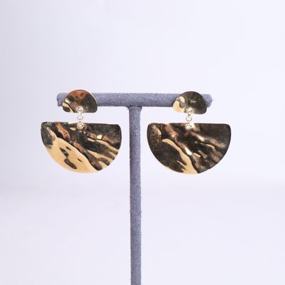 a close up of a pair of earrings on a stand