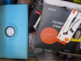a blue case sitting on top of a pile of books