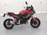 a picture of a red and black motorcycle parked in a white room