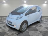 a small white car that is parked in a room