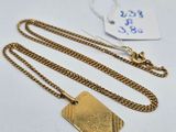 a gold plated necklace with a tag attached to it