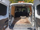 a white van with the door open and a basket in the back