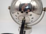 a silver light that is on a stand with a black cord