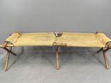 an image of a wooden bench with two legs on a gray floor