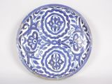 a blue and white plate with a design on it