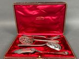 an image of a set of silverware in a red case