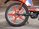 a red motorcycle with a blue and yellow stripe on it