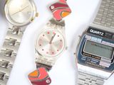 three watches sitting next to each other on a table