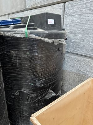 a black trash can sitting next to a black trash can