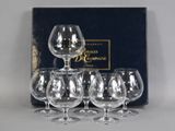 four empty wine glasses are sitting in front of a box