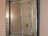 a mirror hanging on the wall above a sink