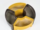 a yellow and black ashtray sitting on a white surface