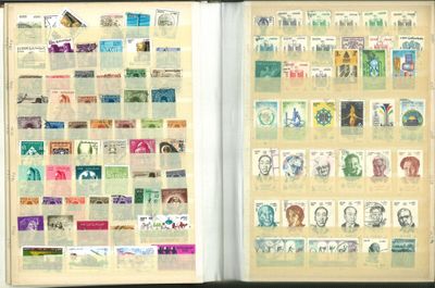an open book with stamps on the pages and a picture of a man ' s face on the pages