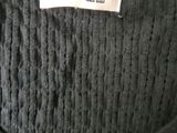 the label is on the back of a black sweater dress