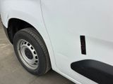 a close up of a white van parked in a parking lot