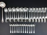 a close up of a bunch of silver spoons and forks