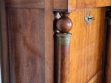 a wooden cabinet with a marble top in a room