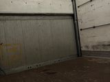 a skateboarder doing a trick on a skateboard in a garage