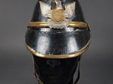 an old helmet with a gold eagle on the top of it