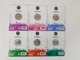 four different types of coins are in a row on a white surface