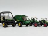a lot of toy tractors that are lined up in a row