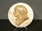 l'image d'une pièce d'or sur laquelle figure le visage d'une femme