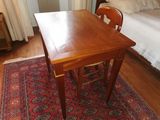 a wooden table and two chairs in a room