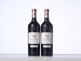 two bottles of wine sitting on top of a table next to each other