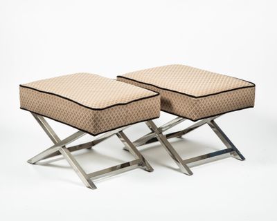 pair of stools with foot rest and cushion on each side