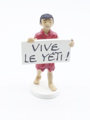 figurine of a man holding a sign that says vive le yet