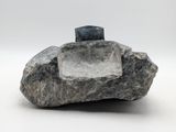 a large rock with a stone in it on a white surface