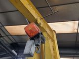 a yellow crane that is hanging from the ceiling