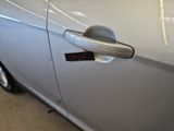 a close up of a car door handle with a sticker on it