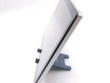 a tablet computer sitting on a stand on a white surface