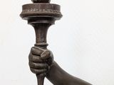 a statue of a man holding a torch in his hand