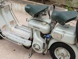 a scooter that is parked on the side of the road