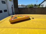 a yellow caution sign on top of a yellow car