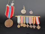 an assortment of medals and medals are displayed on a black surface