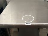 a stainless steel table with a smiley face drawn on it