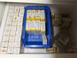 a blue container filled with packages of food and a blue container filled with packages of food