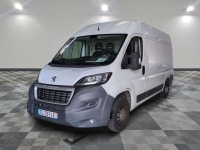 the white van is parked in a large room with a checkered floor