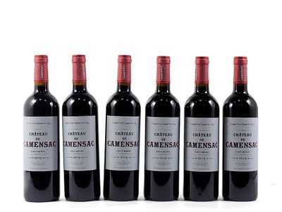 four bottles of wine are lined up on a white surface