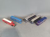 several toy buses and trucks are lined up on a table