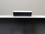a television sitting on top of a table with a remote in it