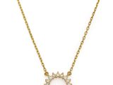 a gold plated necklace with a white diamond flower pendant