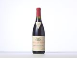 a bottle of red wine sitting on top of a table