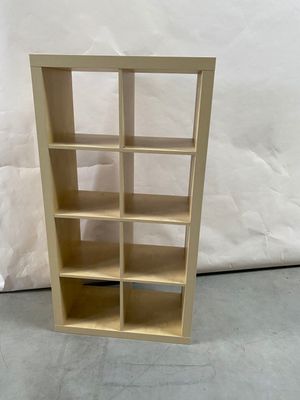 a picture of a wooden bookcase with many shelves