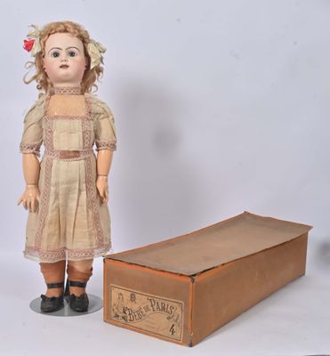a doll that is standing next to a box