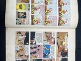 an open comic book with a comic strip in the middle of it